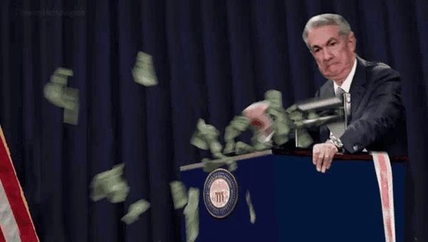 Jerome Powell at a Federal Reserve podium beside a money printer, with bills flying out